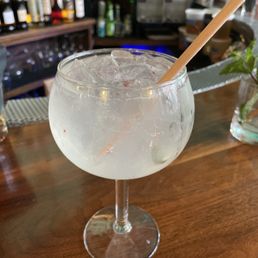 a glass of water with ice and a straw