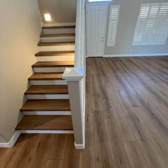 SCT Flooring - Lvp through the entire lower level and on the staircase in this anthem home. We used custom made stairnoses made out of the flooring itsself - Flooring Near Me
