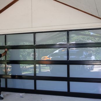 Easy Garage Door Repair - Garage door technician installing a modern glass garage door inside a residential garage. - Garage Door Services Near Me - Houston, Texas Easy Garage Door Repair - Garage door technician installing a modern glass garage door inside a residential garage. - Garage Door Services Near Me - Houston, Texas