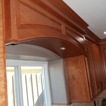 DNA Renovations - a view of a kitchen with wood cabinets - General Contractors Near Me
