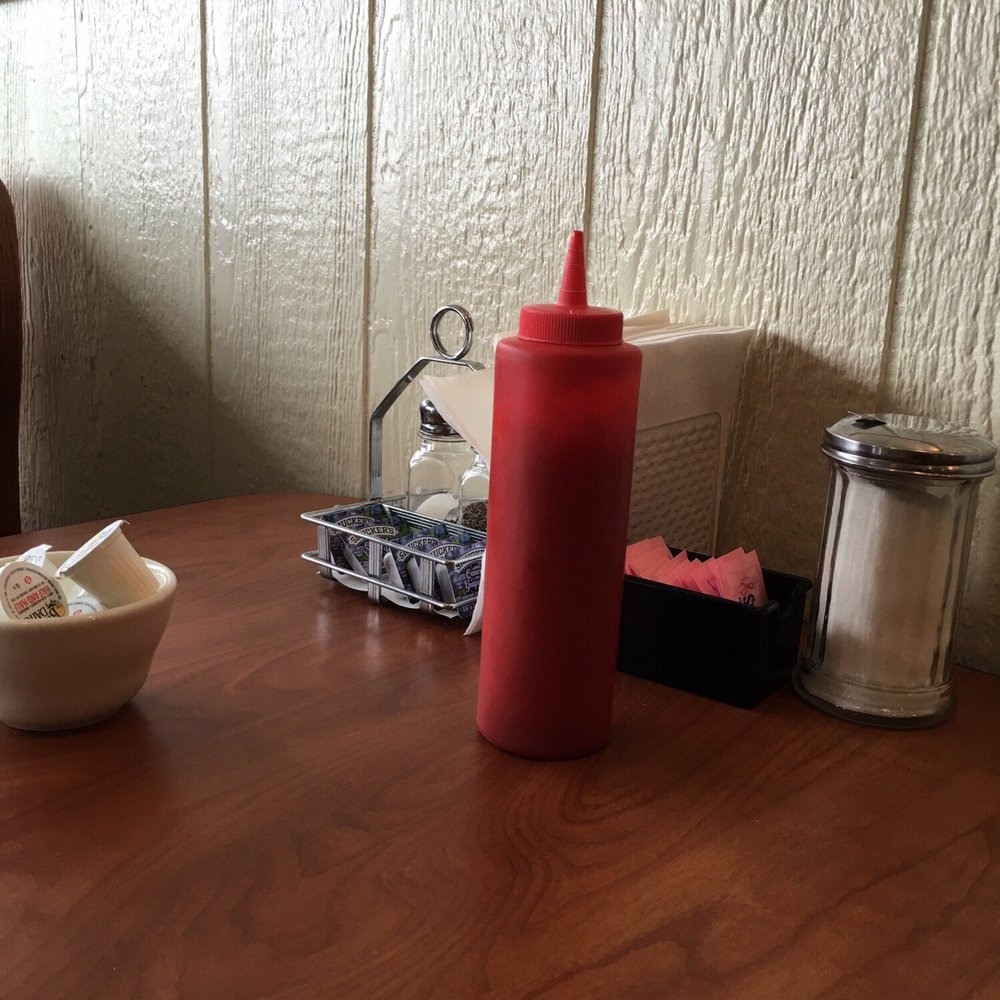 Sallie's Country Kitchen - a table with condiments and condiments - New American Near Me - Nichols, New York Sallie's Country Kitchen - a table with condiments and condiments - New American Near Me - Nichols, New York