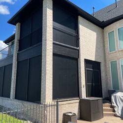 American Patio Enclosures - Fixed solar screen patio enclosure on 1st floor as well as upper level balcony for complete enjoyable outdoor spaces