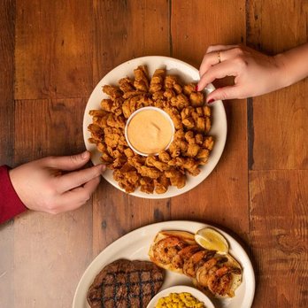 Texas Roadhouse - two plates of food on a wooden table - Steakhouses Near Me - Lansing, Michigan Texas Roadhouse - two plates of food on a wooden table - Steakhouses Near Me - Lansing, Michigan