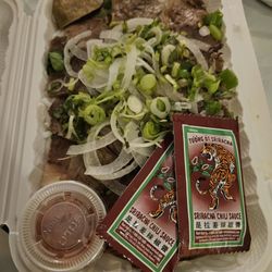 Indochine - Take out order via DoorDash. Bun Bo Hue. Sriracha sauce upcharge ($). Noodles and protein with toppings portion.