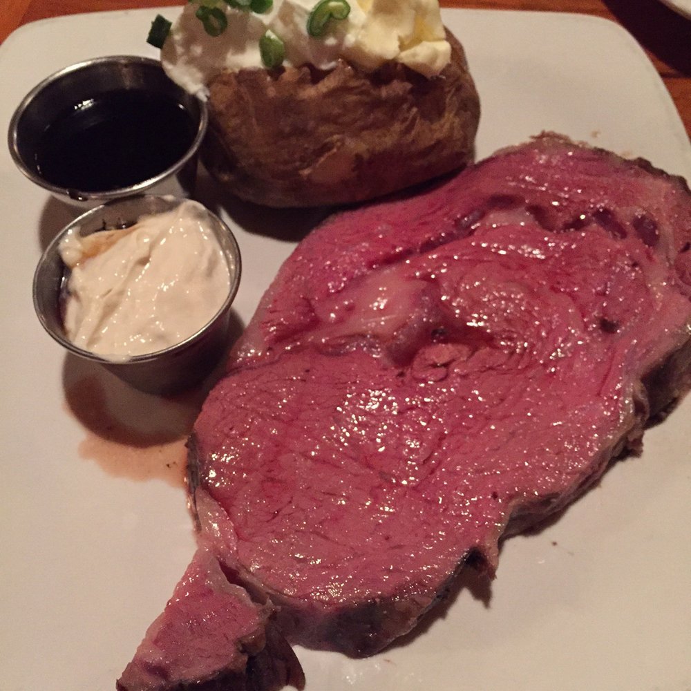 Feeney's Restaurant and Bar - Feeney's famous ribeye, 8oz. Medium Rare, it looks raw but the restaurant was pretty dark. - Bars Near Me - Phoenix, Arizona