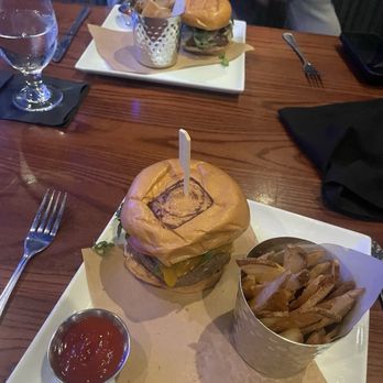 Ocean 302 Bar and Grill - Bison burger (farther back in photo from specials menu) and 302 burger with added bacon (closer in photo and from regular menu) - New American Near Me - Melbourne Beach, Florida