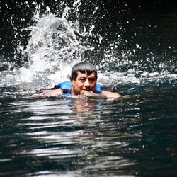 Cenote Yokdzonot - One of the locals clearing up the leaves from the cenote.