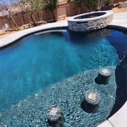 Bar stools, raised spa with rock and waterfall Bar stools, raised spa with rock and waterfall