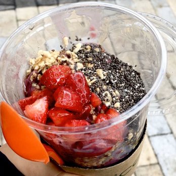 JuiceWell - a hand holding a plastic cup filled with fruit - Juice Bars & Smoothies Near Me - Houston, Texas JuiceWell - a hand holding a plastic cup filled with fruit - Juice Bars & Smoothies Near Me - Houston, Texas
