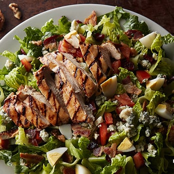 Logan's Roadhouse - Anything & Everything Salad: Hard-boiled egg, bacon, bleu cheese, tomatoes, walnuts, cranberries & chicken with vinaigrette. - Steakhouses Near Me - Kannapolis, North Carolina