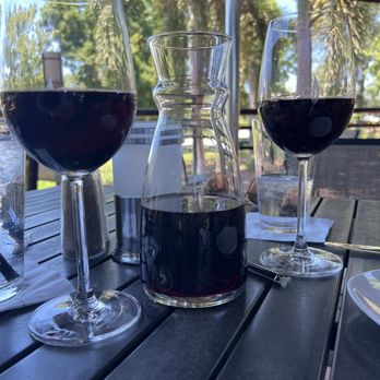 Cooper’s Hawk Winery & Restaurant - Wine carafe of reserve red wine.  Outdoor seating near the fountain - American Near Me - Tampa, Florida