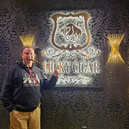 Inside their shop enjoying a stogie Inside their shop enjoying a stogie