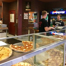 a man serving pizza