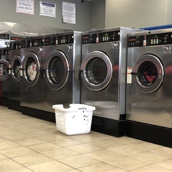 Suds Laundromat - Washing machines neatly arranged with largest in center and stair stepping to either side - Laundromat Near Me - Savannah, Georgia