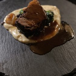 Colgate Inn - Braised short ribs over parsnip purée, roasted shallot and spinach underneath.