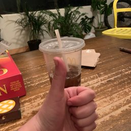 a hand holding a cup of coffee