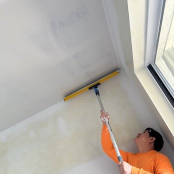 Ivy Drywall Remodeling - a man using a sque - Drywall Installation & Repair Near Me Ivy Drywall Remodeling - a man using a sque - Drywall Installation & Repair Near Me