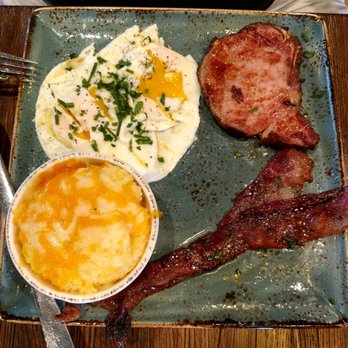 First Watch - Pork chop with fried eggs and grits. The million dollar bacon is a separate side order so worth it too! - Breakfast & Brunch Near Me - League City, Texas First Watch - Pork chop with fried eggs and grits. The million dollar bacon is a separate side order so worth it too! - Breakfast & Brunch Near Me - League City, Texas