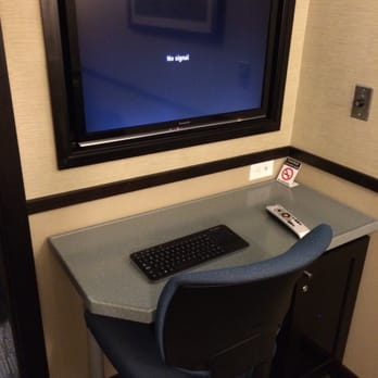 Minute Suites - Work desk area with television! The switch to the right is for white noise!  It's great! - Airport Lounges Near Me - Dallas, Texas