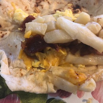 Las Palmas Cafe - Insides of potato egg bacon cheese. Me likes. Could be more bacon, but when can't you have more bacon. - Mexican Near Me - Seguin, Texas
