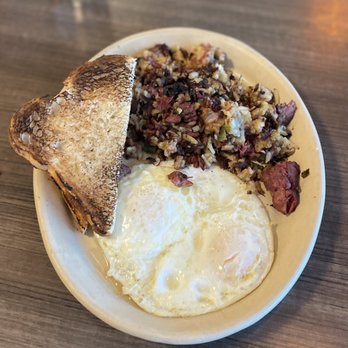 Snooze, an A.M. Eatery - Corned beef and hash w eggs over easy and sourdough ($13) 5/2023 - Breakfast & Brunch Near Me - Tucson, Arizona