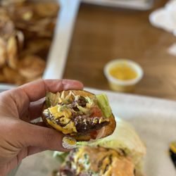 MOOYAH Burgers, Fries & Shakes - The MDC on lettuce on top of a hot crispy potato chip