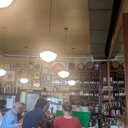 Small restaurant with limited seating, bustling with happy diners Small restaurant with limited seating, bustling with happy diners