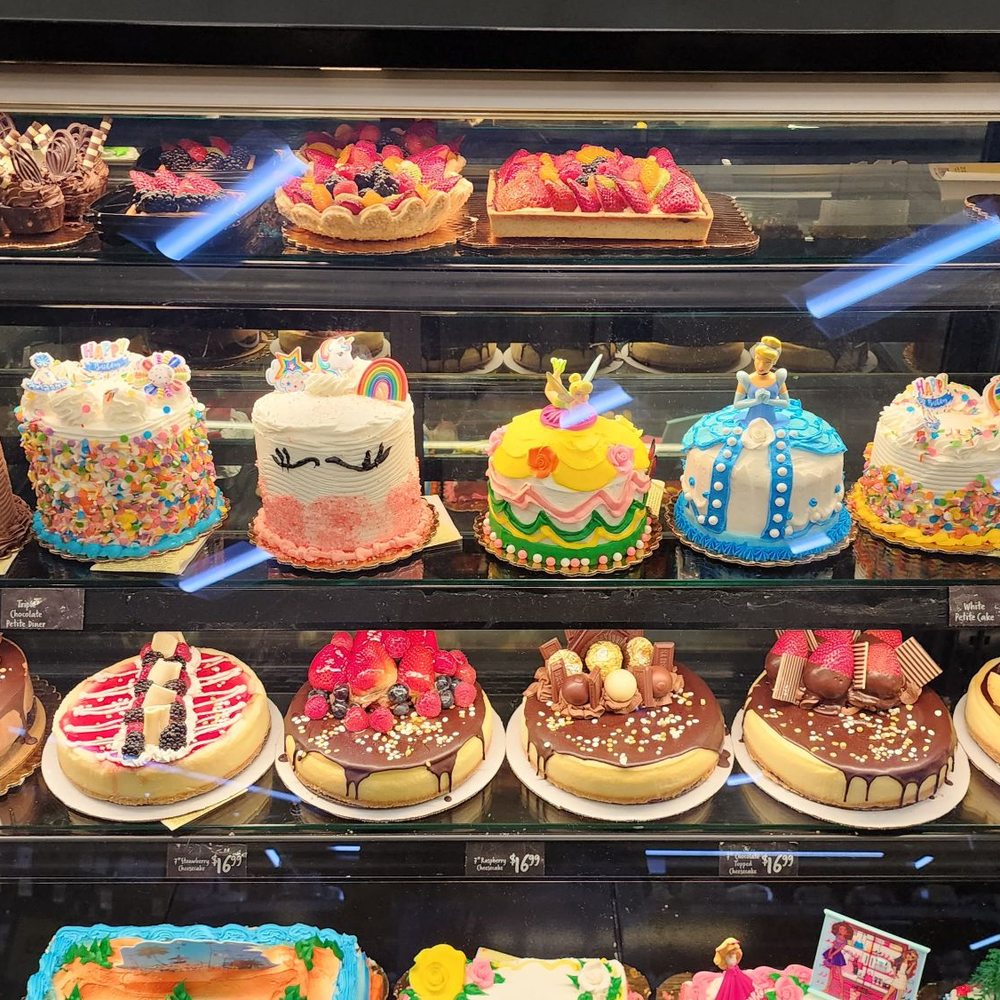 a variety of cakes in a display case a variety of cakes in a display case