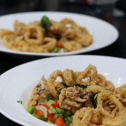 Golden crispy calamari served fresh with vibrant vegetables. A delicious seafood favorite at Taroko Asian Bar & Grill in Redding.