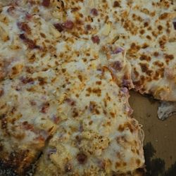 Uncle John's Pizza - Crust has parmesan cheese . Pineapple with ham and extra cheese.