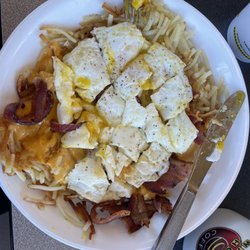 Waffle House - Two over medium eggs atop crispy hash browns and bacon and cheese! Bacon Egg & Cheese Hashbrown Bowl