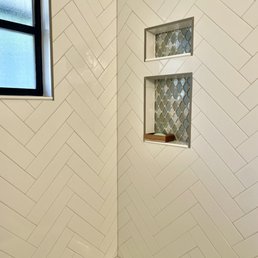 a corner of a bathroom with a window a corner of a bathroom with a window