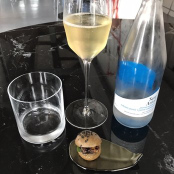 The Man Behind The Curtain - The mini burger paired with a glass of Krug - British Near Me - Leeds, XWY