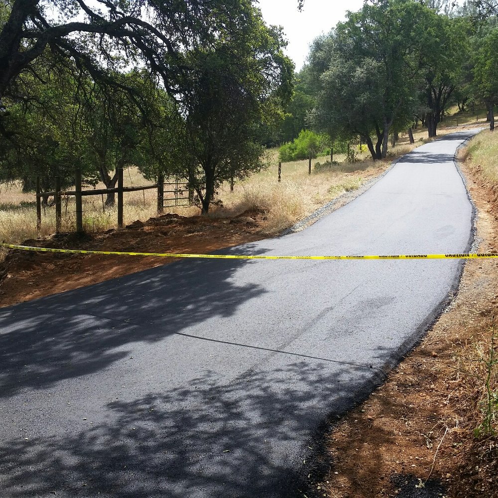 Johnson Asphalt Paving - a paved road with yellow tape - General Contractors Near Me - Auburn, California Johnson Asphalt Paving - a paved road with yellow tape - General Contractors Near Me - Auburn, California