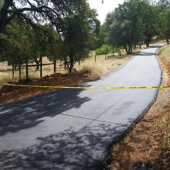 Johnson Asphalt Paving - a paved road with yellow tape - General Contractors Near Me - Auburn, California