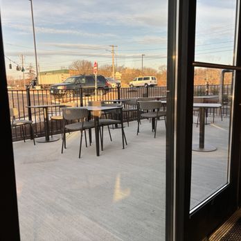 Starbucks - a patio with tables and chairs and a view of a parking lot - Coffee & Tea Near Me - Manchester, Connecticut