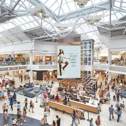 Freehold Raceway Mall - View from the second level overlooking Freehold Raceway Mall's busy center court and digital display.