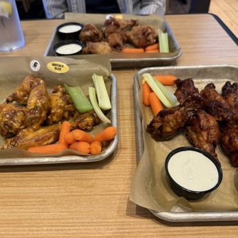 Buffalo Wild Wings - (Clockwise from top): Lemon Pepper, Caribbean Jerk, Buffalo Blue - Sports Bars Near Me - Prattville, Alabama Buffalo Wild Wings - (Clockwise from top): Lemon Pepper, Caribbean Jerk, Buffalo Blue - Sports Bars Near Me - Prattville, Alabama