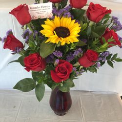 Red roses one sunflower