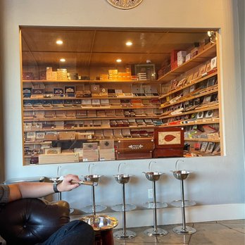 Aztec Cigars & Lounge - a man sitting on a couch - Cigar Bars Near Me - Monrovia, California