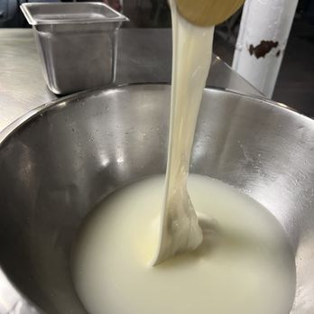 Selfup Cooking Classes - Stretching the mozzarella in the hot water with wooden spoons - Cooking Classes Near Me - New York, New York