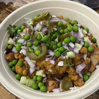 Chopathi - Chicken vindaloo rice bowl with toppings, vindaloo sauce is near the bottom and darker/spicy - Indian Near Me - Tysons Corner, Virginia
