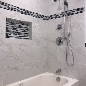Torres Renovation - a bathtub and shower in a bathroom - General Contractors Near Me - Gaithersburg, Maryland Torres Renovation - a bathtub and shower in a bathroom - General Contractors Near Me - Gaithersburg, Maryland