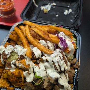 NYC Halal Eats - Monster Platter: falafel, lamb, and chicken served on top of rice with a side of salas and fries - Mediterranean Near Me - Niles, Illinois