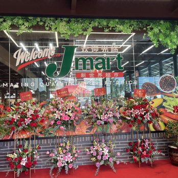 JMart - a display of flowers in front of a store - International Grocery Near Me - Queens, New York