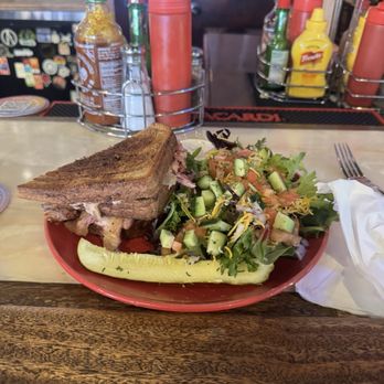 The Local 907 - Rueben Sandwich and salad with pickle on the side - Pubs Near Me - Renton, Washington The Local 907 - Rueben Sandwich and salad with pickle on the side - Pubs Near Me - Renton, Washington