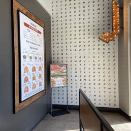 a restaurant with a large menu on the wall a restaurant with a large menu on the wall