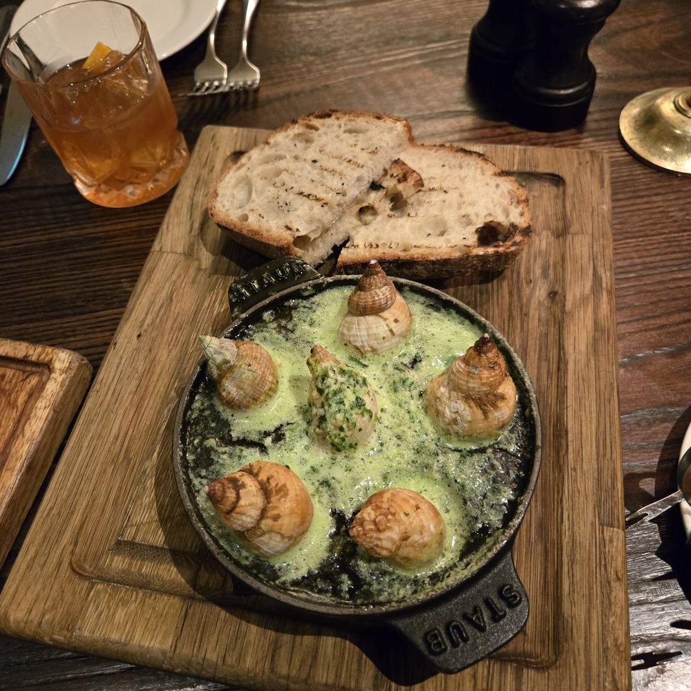 The Jugged Hare - Sea snails with butter, garlic and sourdough - Brasseries Near Me - London, XGL The Jugged Hare - Sea snails with butter, garlic and sourdough - Brasseries Near Me - London, XGL