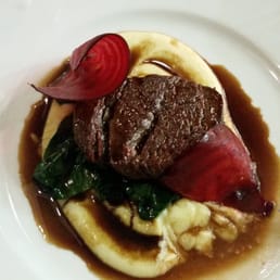 Steak in a port wine sauce over steamed spinach and truffle mashed potatoes.