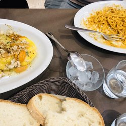 Il Lupicante - Ravioli with burrata and fish and orange tomatoes. (left) Spaghetti with lobster. (Right)